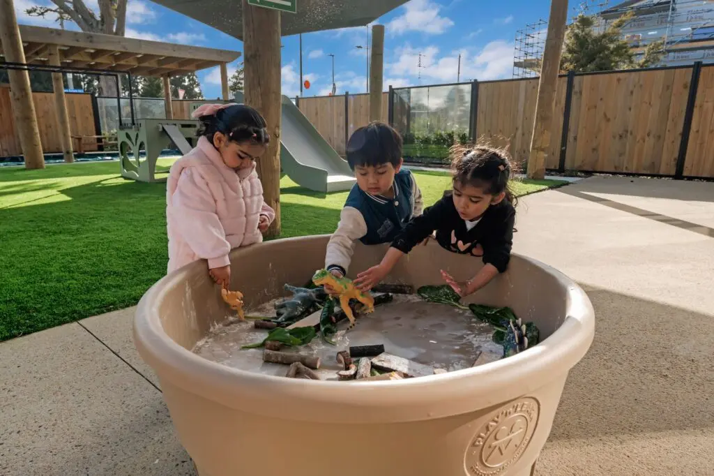 A Fern-green All-in-One PlayTray in a well-established outdoor early-learning centre