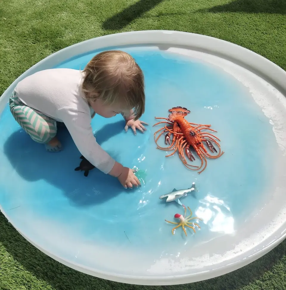 All-in-One PlayTray lid sitting flat on the ground as a shallow infant tray
