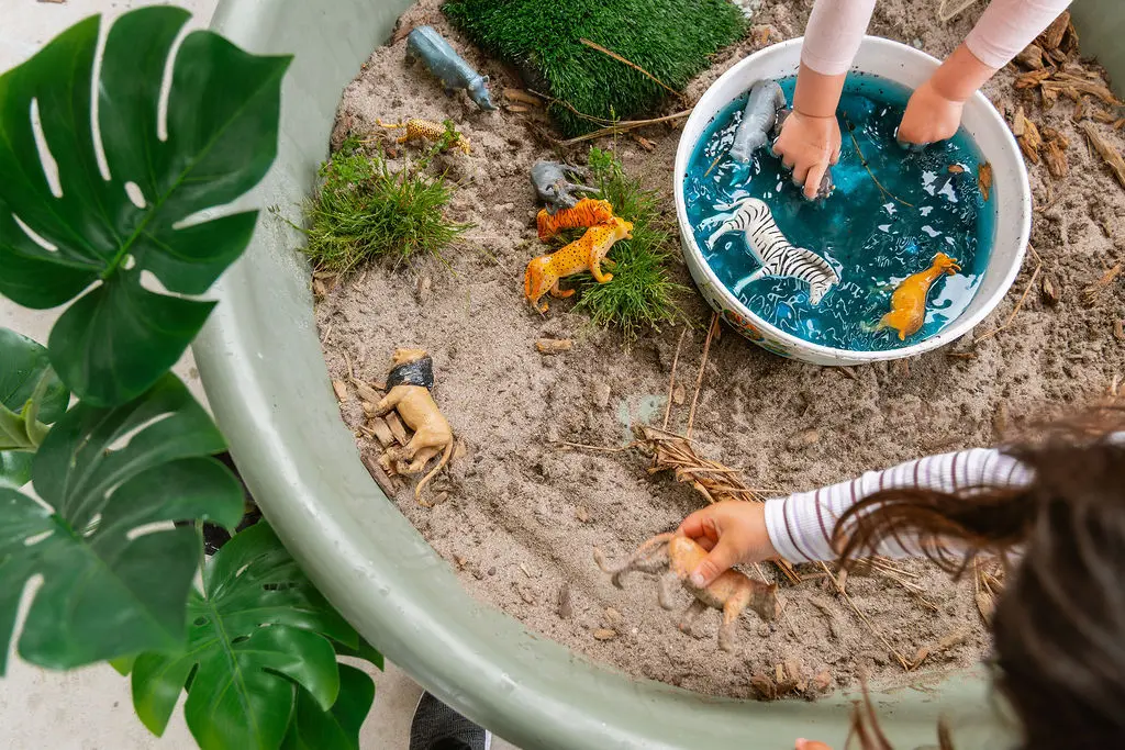 Overhead small-world: sand, water and animals in a Sage PlayTray