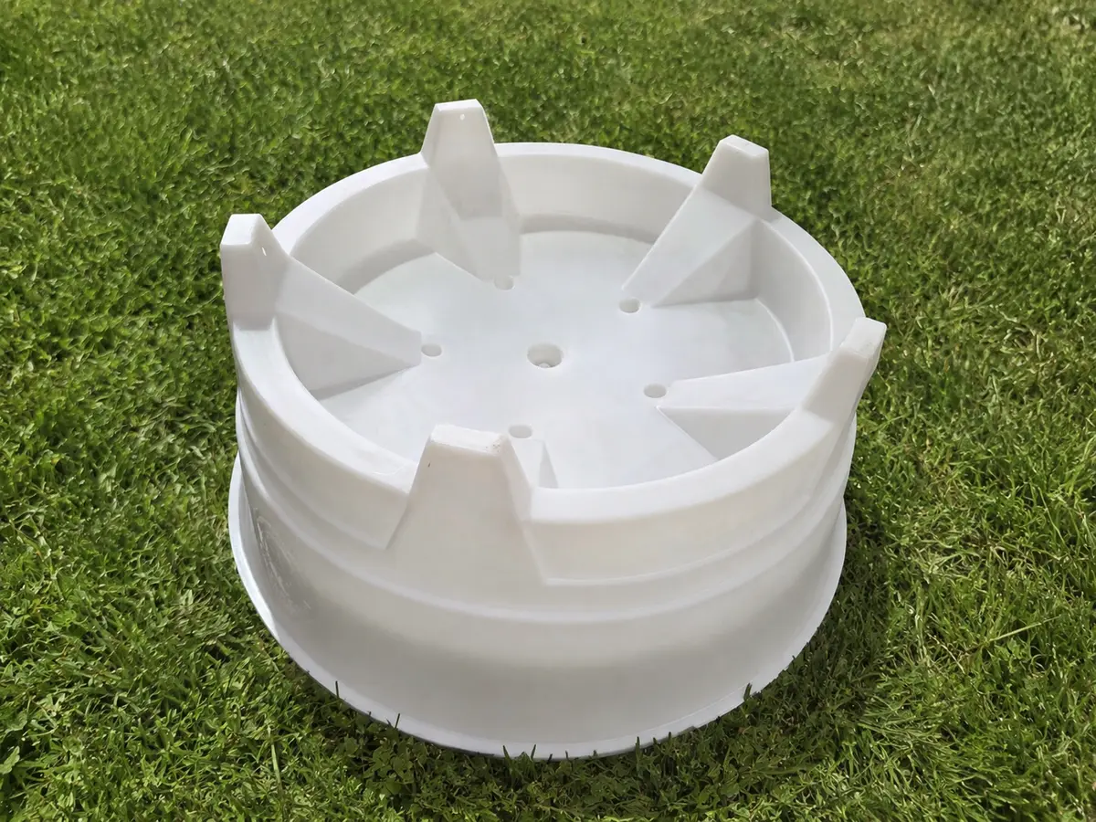 White All-in-One PlayTray inverted on grass, legs in the air